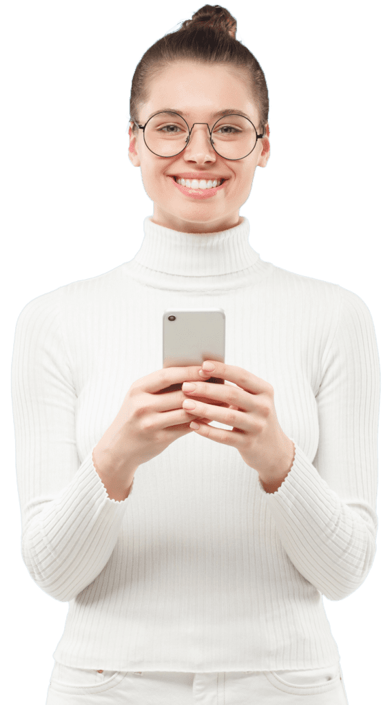 Portrait of young teen girl in white turtleneck and eyegalsses, standing with phone in hands, isolated on blue background